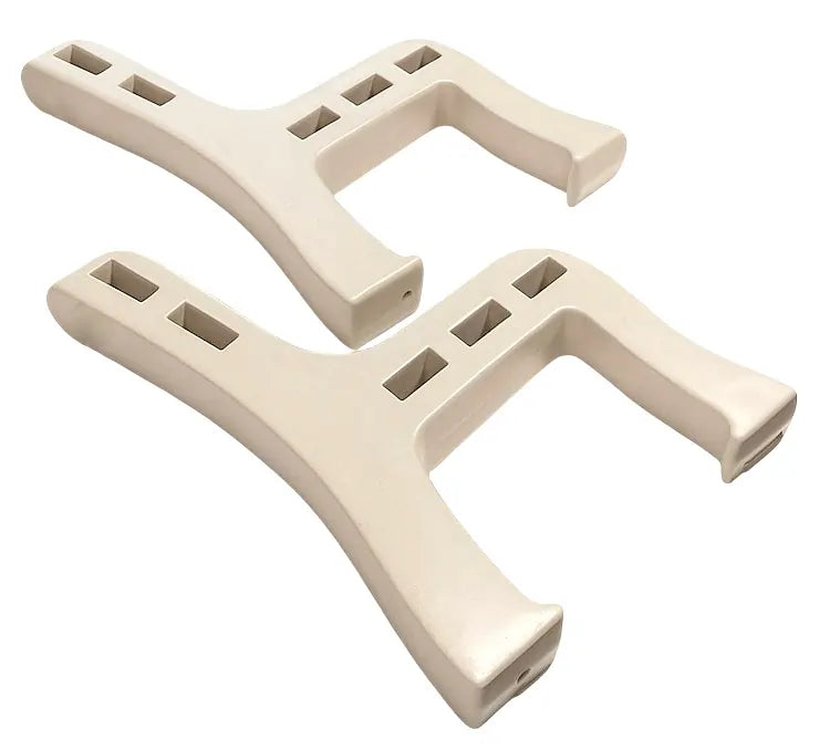Two beige plastic brackets on a white background